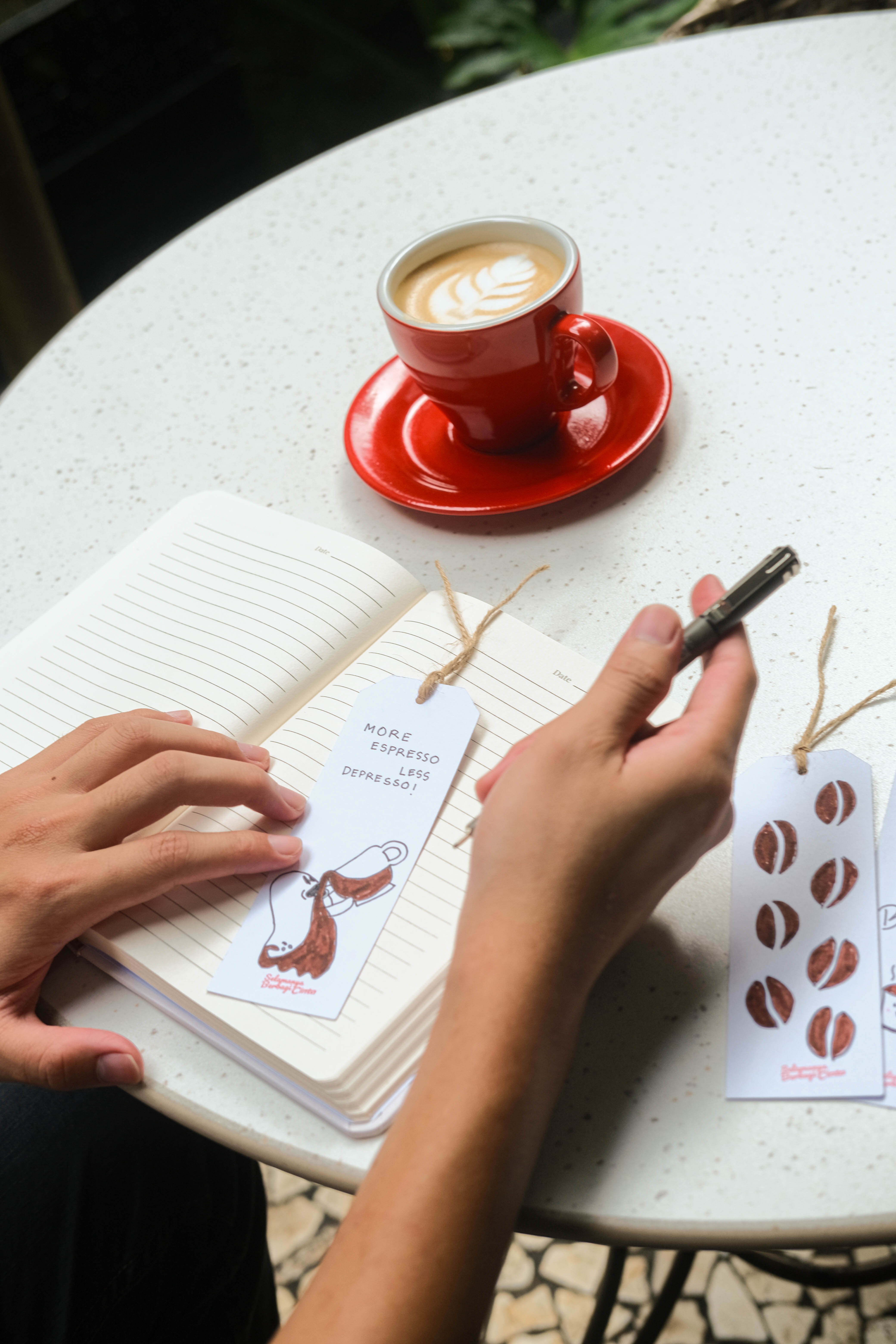 Writing with bookmark and coffee